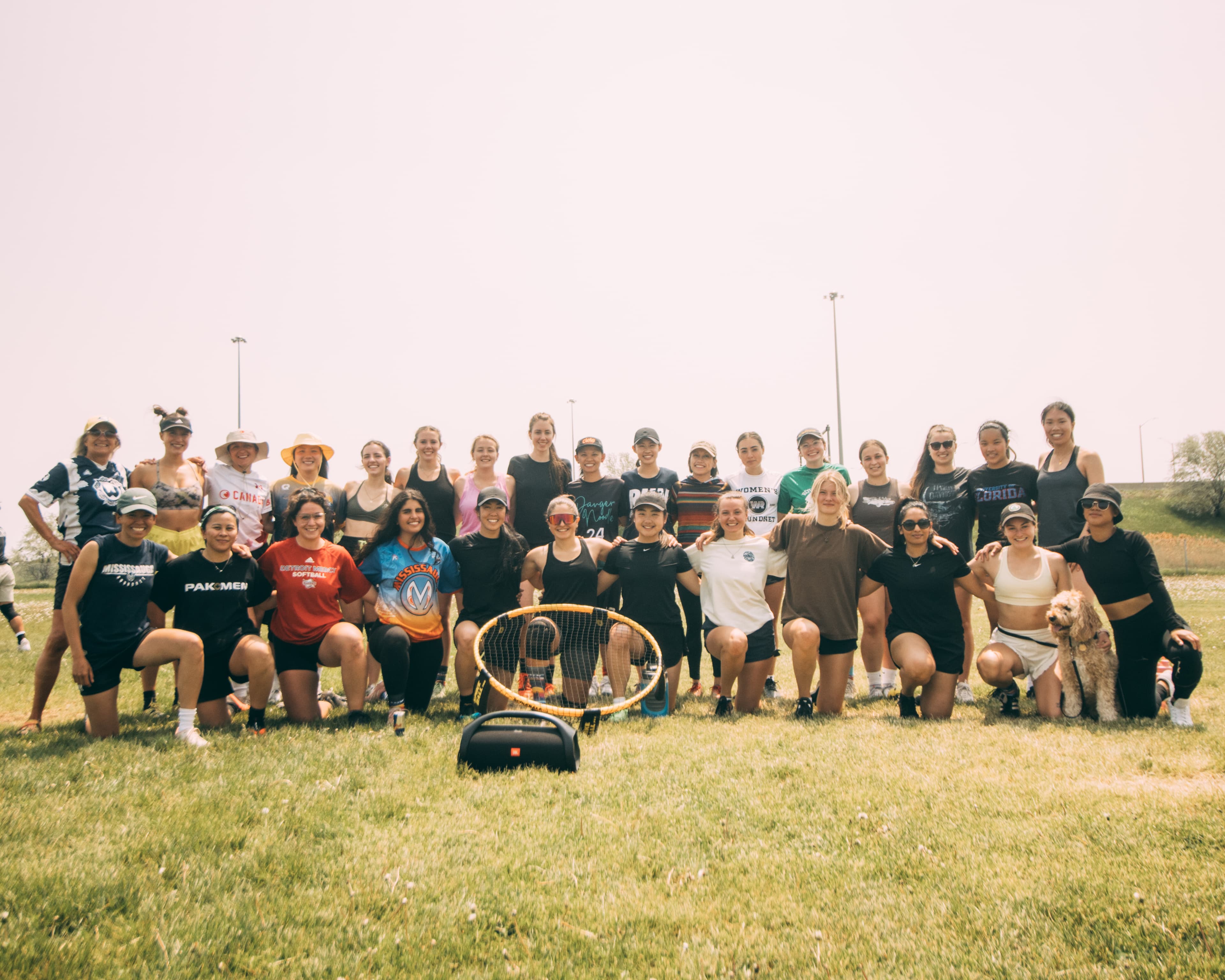 People sitting around a spikeball net